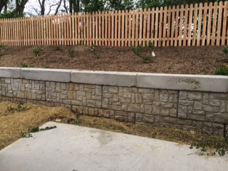 Patio, retaining wall and 5 foot fence above