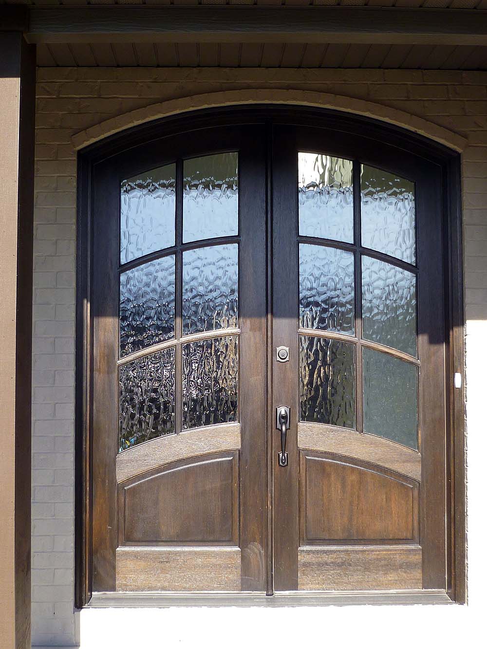 <p>Arch topped wood double entry doors</p>
