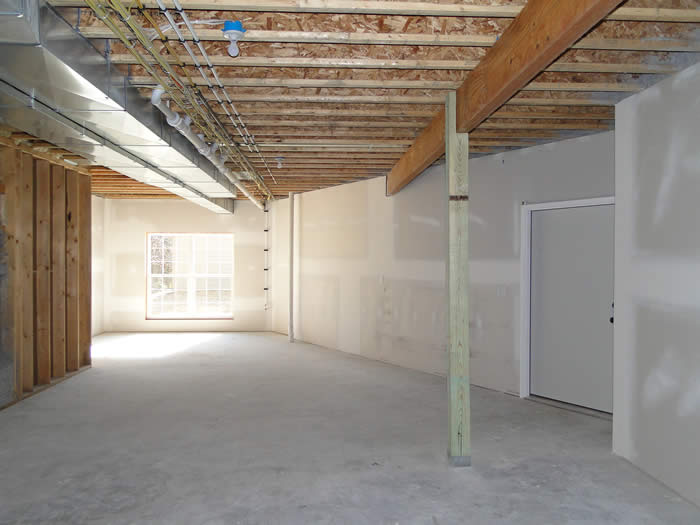 <p>Unfinished basement with drywall on walls</p>