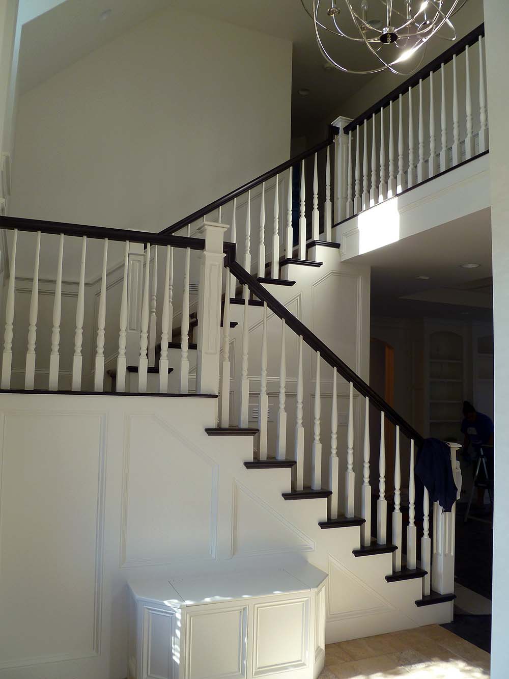Open staircase with wood balusters and boxed newell posts