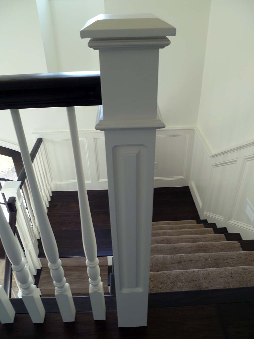 Open staircase with wood balusters and boxed newell posts