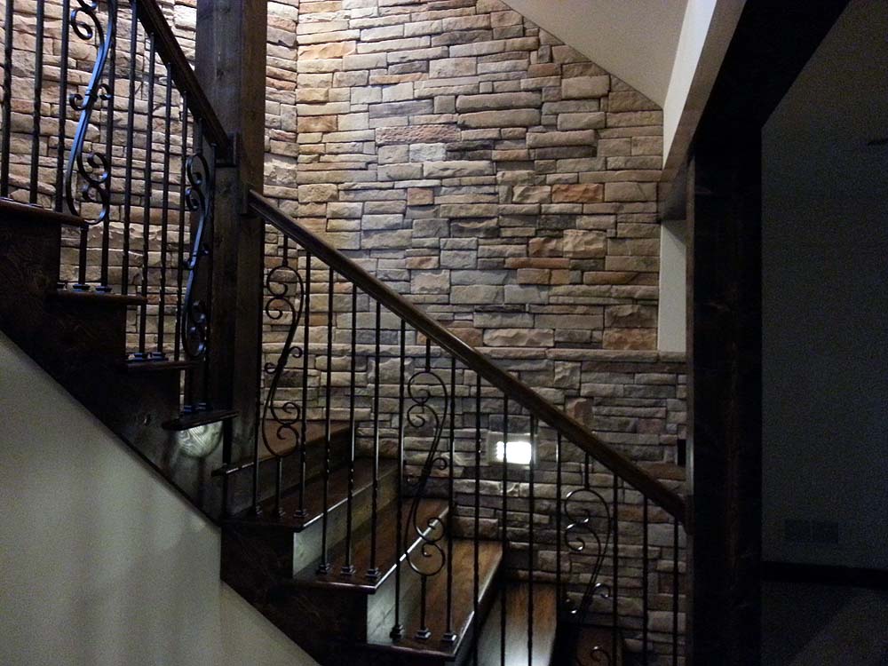 Staircase to lower level with stone walls