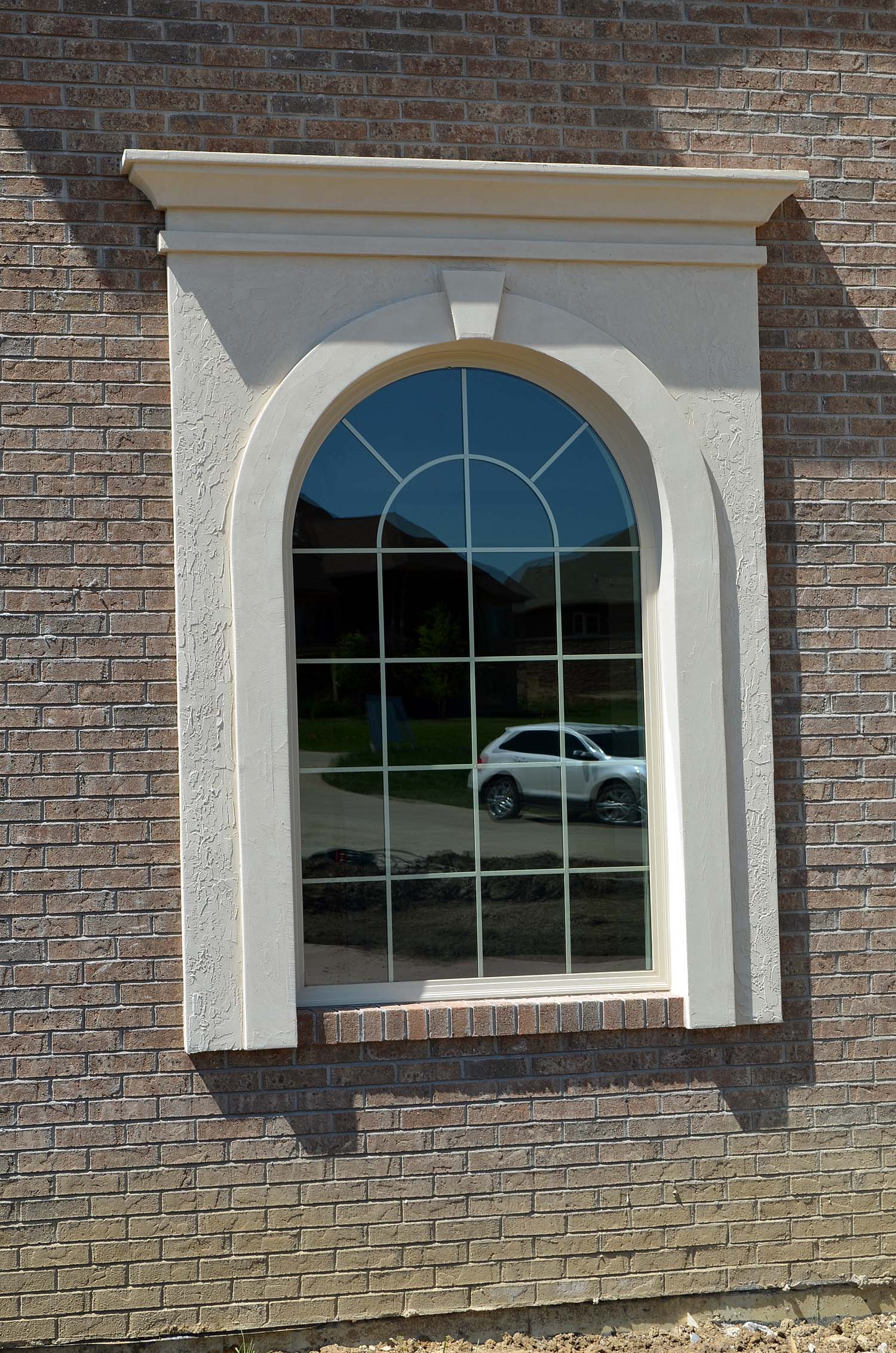 Stucco window trim on brick