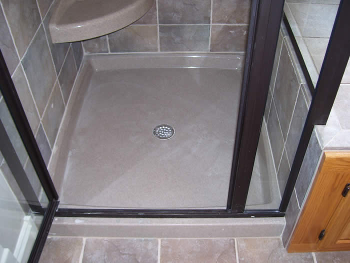 Onyx shower base with glass walls.